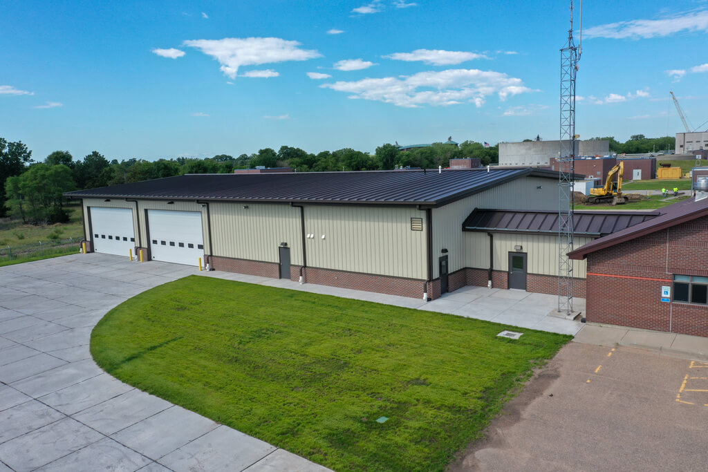 Industrial metal building with two large garage door openings.