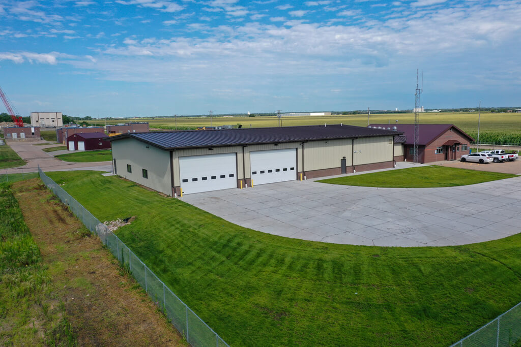 Industrial metal building with two large garage door openings.