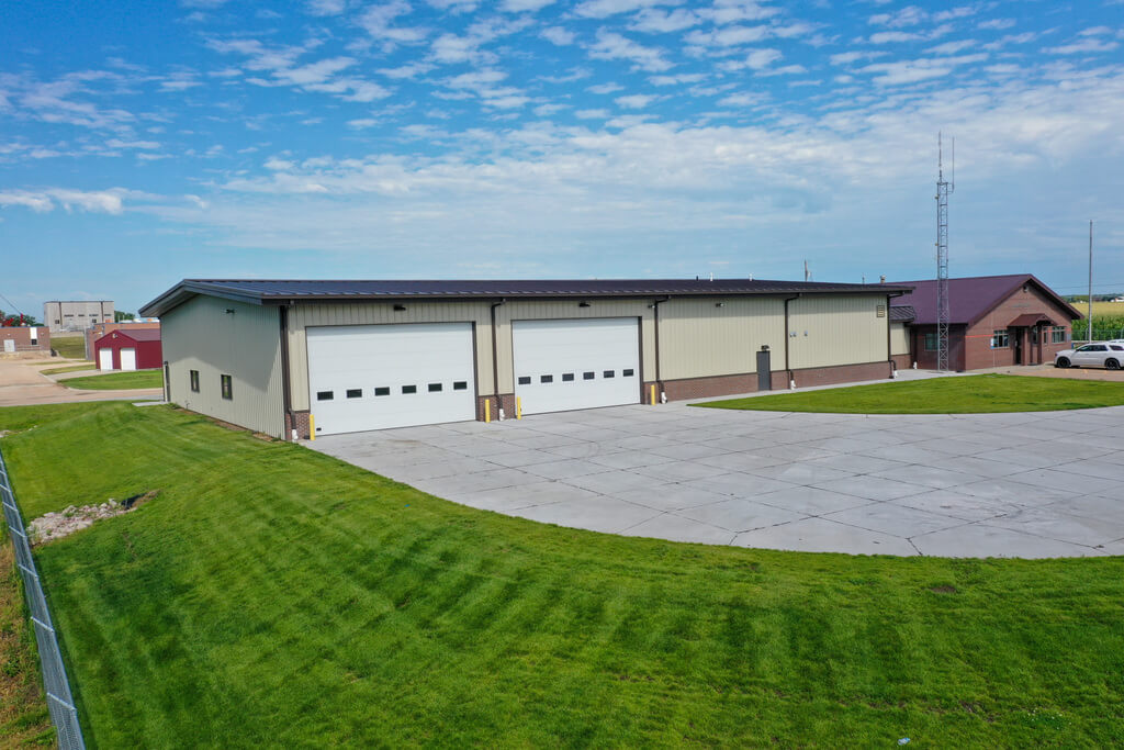 Industrial metal building with two large garage door openings.