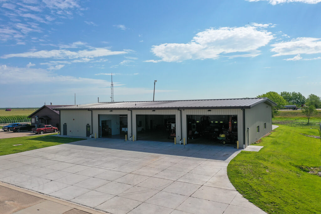 Industrial metal building with three large garage door openings.